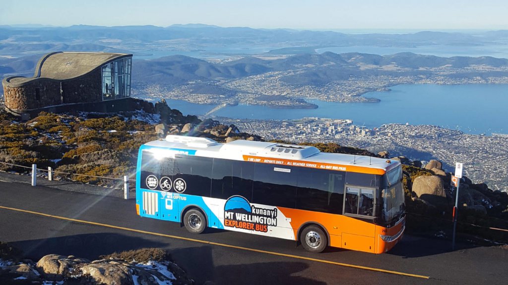 Mt Wellington bus at the summit of kunanyi/Mt Wellington. A sunny day with spectacular views over Hobart.